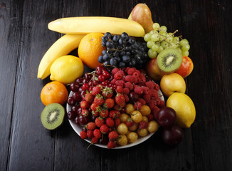 fruits and berries on wooden background