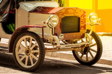 The front of old vintage car with shining bumper and reflector.