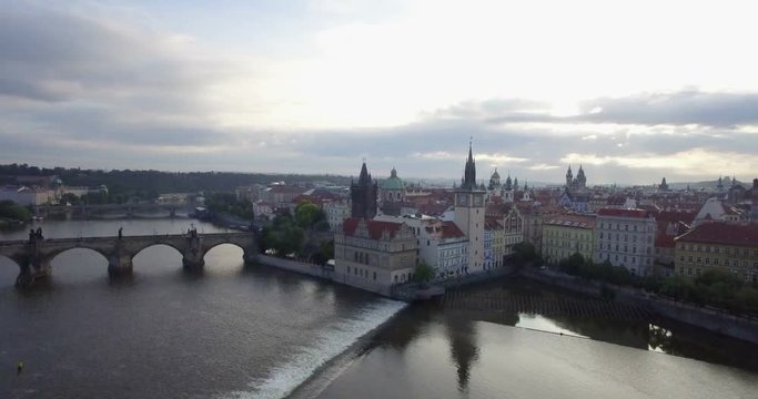 Aerial footage panning from the Charles Bridge to Prague Skyline. Shot at dawn in 4K