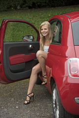 TEENAGE GIRL WITH A RED CAR - A blond teenage driver with long legs and her red car