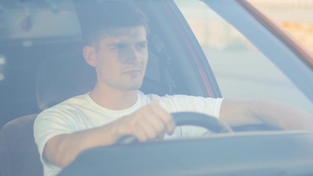portrait of a young man behing the wheel, slow-motion