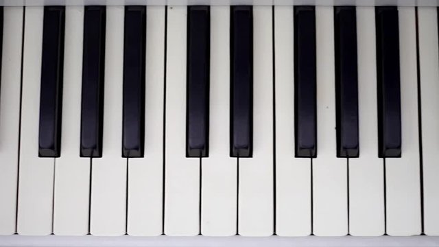 Piano keyboard background with selective focus in motion.