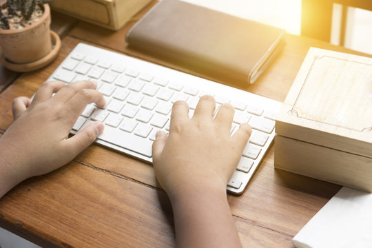 Kid's Hand On Computer Keyboard