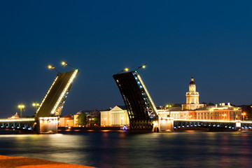 Fototapeta na wymiar Divorced Palace Bridge during the White Nights view on Kuntskamera , St. Petersburg, Russia. July 3, 2010