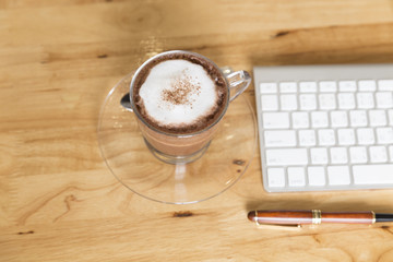 hot cocoa chocolate drink with computer keyboard and pen