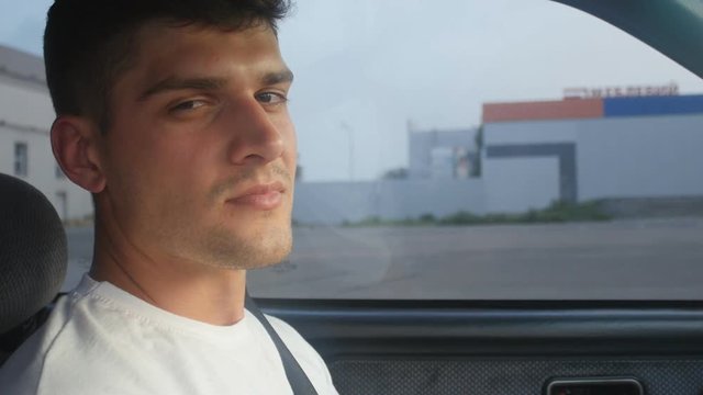 portrait of a young man behing the wheel, slow-motion