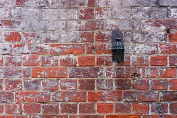 Red brick wall with a lantern