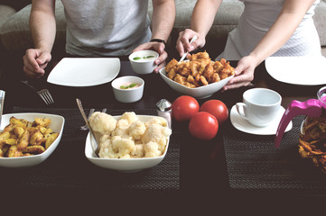 Couple eats dinner at home. Performed in vintage stylization