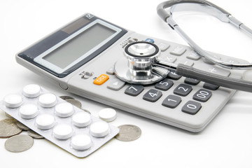 Calculator and stethoscopes on white background