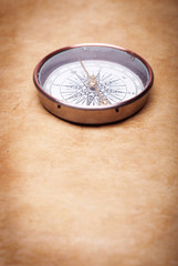 Fototapeta na wymiar antique compass on vintage paper background