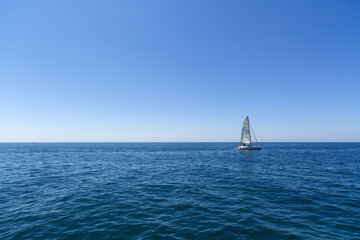 Obraz premium Racing yacht in the Mediterranean sea on blue sky background