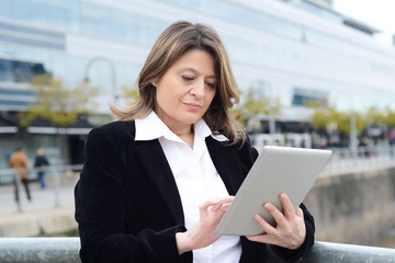 Portrait of business woman using her tablet.