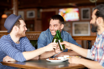 happy male friends drinking beer at bar or pub