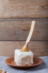 Butter on plate, clay pot and spoon on linen napkin. Rustic stil