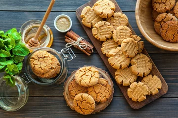 Foto op Plexiglas peanut butter and honey cookies on a dark wood background. selective focus © natapetrovich