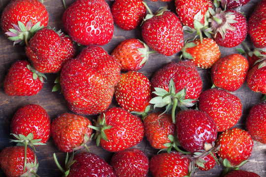 Lots of fresh bright red strawberries. Selective focus. Shallow