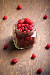 Lots of fresh bright red raspberries. Selective focus. Shallow d