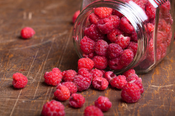 Lots of fresh bright red raspberries. Selective focus. Shallow d