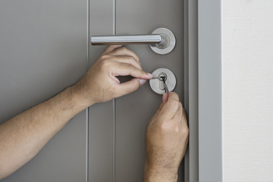 locksmith try to fix a key lock door for open it - can use to display or montage on product