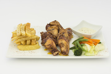 Fried Chicken Wings with fries, salad and chili sauce.  