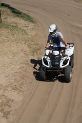 Man or young boy is driving a quad 