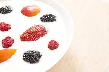 Natural yogurt with fruits and berries in the bowl. Colorful background. Healthy food and lifestyle. Close up view