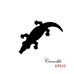 The black silhouette of a krocodile on a white background. Element for design