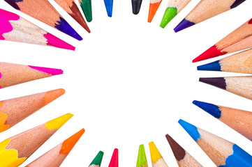 Colored pencils in a circle on a white background closeup