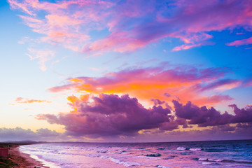 Obraz premium Wonderful sunset over a quiet sea and view of seafront in Sardinia, Italy.