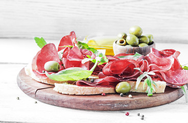 Antipasto with olive and bresaola, Selective focus
