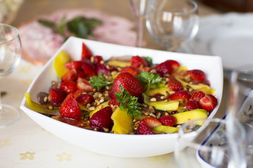 Fruit salad, dessert. Strawberries and mangoes in sweet and sour sesame sauce. 