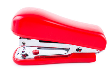 Stapler of red color isolated on white background.