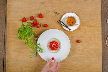 strawberry cake with tea and cinnamon on wooden background
