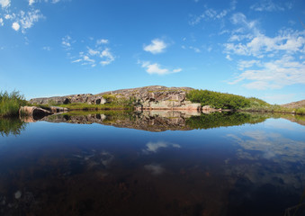 reflection in the lake. The coast of the Barents Sea