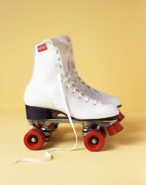 Roller skates on yellow background