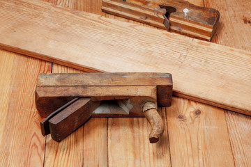 Two planes and board on a wooden table.