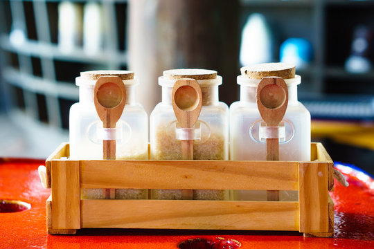 Coffee-Mate Sugar in jars focus on wood spoon
