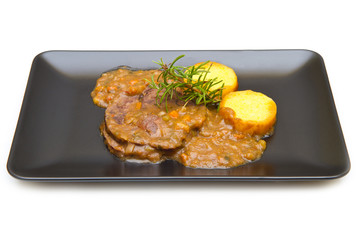 braised meat with polenta on white