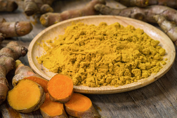 Fresh turmeric roots with turmeric powder