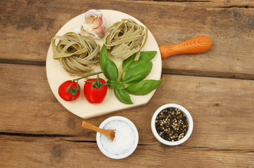 Tagliatelle ingredients on wooden background