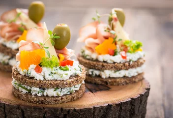 Tuinposter Canapes with prosciutto and cheese  © pilipphoto