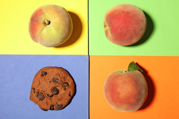 Peaches with cookie on colorful background