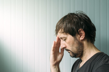 Profile portrait od miserable troubled man