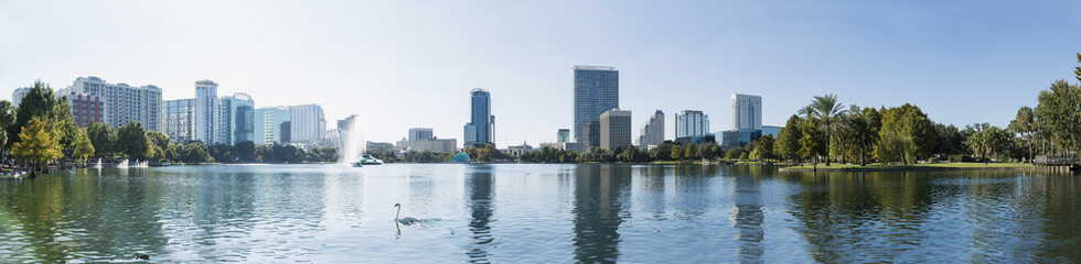 Fototapeta na wymiar Orlando downtown Lake Eola panorama with urban buildings and reflection