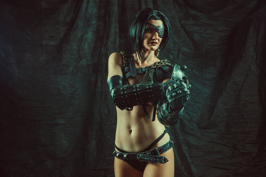 Powerful one-eyed steam punk woman in metal lingerie is showing