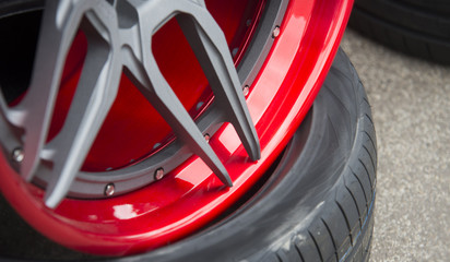 Closeup detail of Red Aluminum car wheel