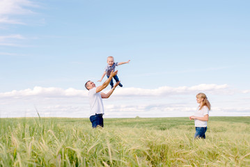 Fototapeta premium parents play with the son outdoors