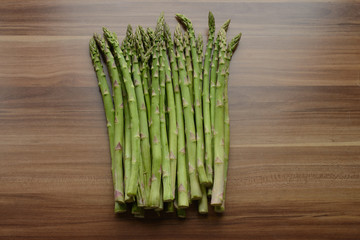 fresh green asparagus on wooden table