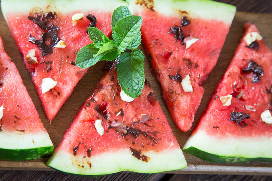 Watermelon slice popsicles with chocolate, nuts and mint
