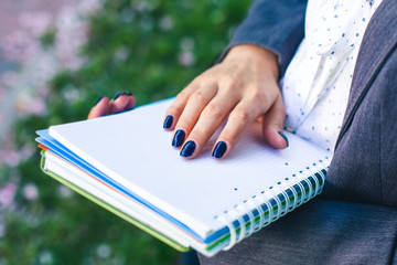 student girl with study sheets and glossary book close-up